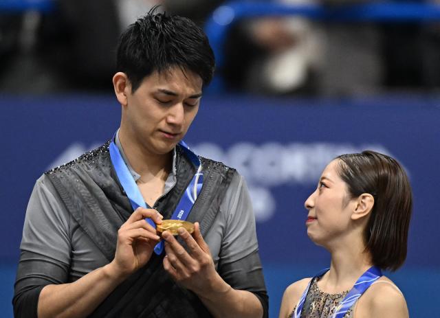 Gold medallists Japan's Riku Miura and Japan's Ryuichi Kihara pose on the podium of the figure skating pair skating free skating final during the Milano Cortina 2026 Winter Olympic Games at Milano Ice Skating Arena in Milan on February 16, 2026. (Photo by Gabriel BOUYS / AFP)