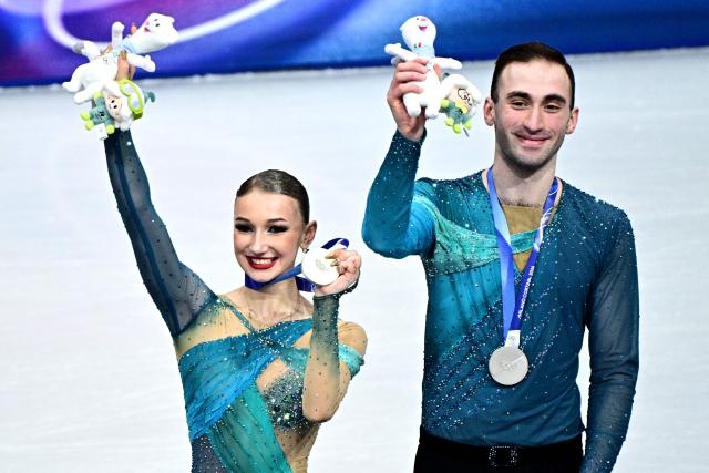 Silver medallists Georgia's Anastasiia Metelkina and Luka Berulava pose on the podium of the figure skating pair skating free skating final during the Milano Cortina 2026 Winter Olympic Games at Milano Ice Skating Arena in Milan on February 16, 2026. (Photo by JULIEN DE ROSA / AFP)