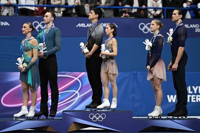 Silver medallists Georgia's Anastasiia Metelkina and Georgia's Luka Berulava, gold medallists Japan's Riku Miura and Japan's Ryuichi Kihara, and bronze medallists Germany's Minerva Fabienne Hase and Germany's Nikita Volodin stand on the podium of the figure skating pair skating free skating final during the Milano Cortina 2026 Winter Olympic Games at Milano Ice Skating Arena in Milan on February 16, 2026. (Photo by Gabriel BOUYS / AFP)