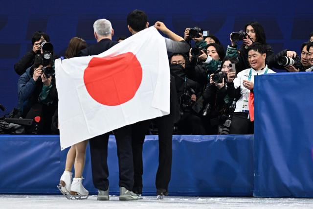 Gold medallists Japan's Riku Miura and Ryuichi Kihara pose with a Japanese flag after the victory ceremony of the figure skating pair skating free skating final during the Milano Cortina 2026 Winter Olympic Games at Milano Ice Skating Arena in Milan on February 16, 2026. (Photo by Gabriel BOUYS / AFP)