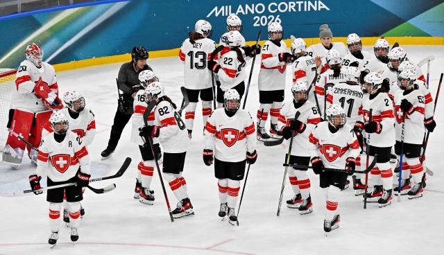 Switzerland's teammates react at the end of the women's play-off semi-final ice hockey match between Canada and Switzerland at the Milano Santagiulia Ice Hockey Arena during the Milano Cortina 2026 Winter Olympic Games in Milan, on February 16, 2026. Canada wins 2 - 1 against Switzerland and qualifies for the final. (Photo by Alexander NEMENOV / AFP)