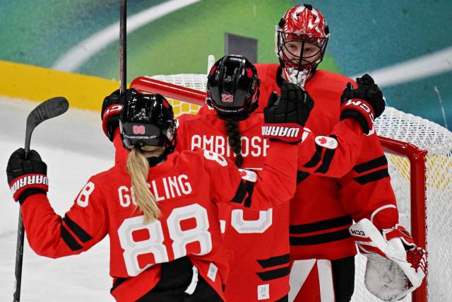Canada's teammates celebrate at the end of the women's play-off semi-final ice hockey match between Canada and Switzerland at the Milano Santagiulia Ice Hockey Arena during the Milano Cortina 2026 Winter Olympic Games in Milan, on February 16, 2026. Canada wins 2 - 1 against Switzerland and qualifies for the final. (Photo by Alexander NEMENOV / AFP)