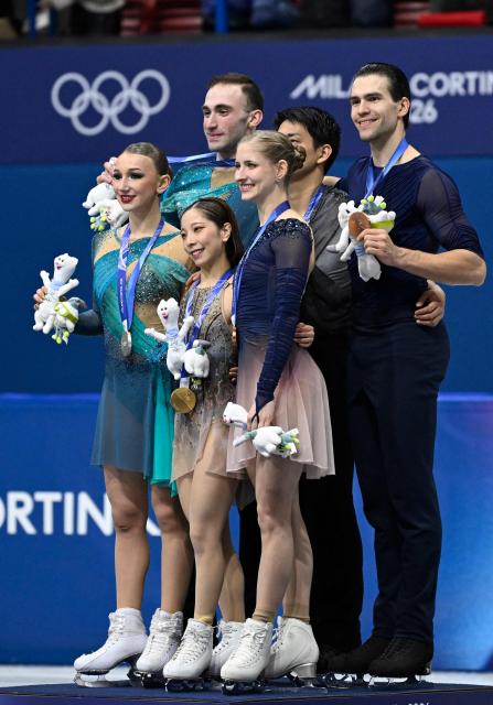 Silver medallists Georgia's Anastasiia Metelkina and Georgia's Luka Berulava, gold medallists Japan's Riku Miura and Japan's Ryuichi Kihara, and bronze medallists Germany's Minerva Fabienne Hase and Germany's Nikita Volodin pose on the podium of the figure skating pair skating free skating final during the Milano Cortina 2026 Winter Olympic Games at Milano Ice Skating Arena in Milan on February 16, 2026. (Photo by WANG Zhao / AFP)