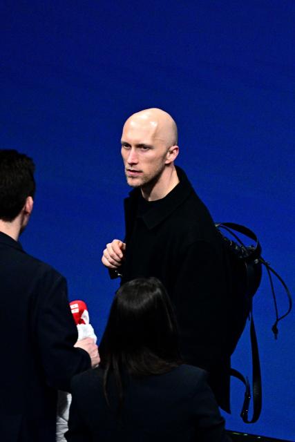 Former French skater and choreographer Benoit Richaud leaves after watching the figure skating pair skating free skating final during the Milano Cortina 2026 Winter Olympic Games at Milano Ice Skating Arena in Milan on February 16, 2026. (Photo by JULIEN DE ROSA / AFP)