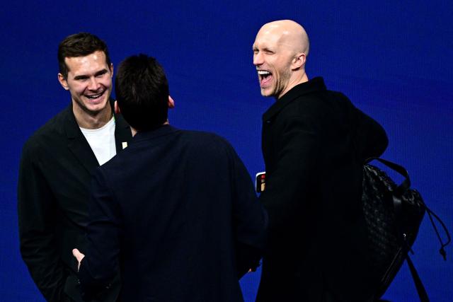 Former French skater and choreographer Benoit Richaud (R) leaves after watching the figure skating pair skating free skating final during the Milano Cortina 2026 Winter Olympic Games at Milano Ice Skating Arena in Milan on February 16, 2026. (Photo by JULIEN DE ROSA / AFP)