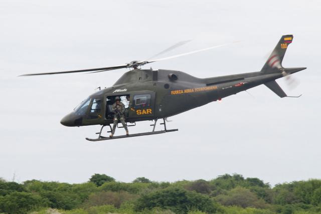 An Ecuadorian Air Force helicopter flies over the city of Manta in Ecuador on February 16, 2026. (Photo by Gerardo MENOSCAL / AFP)
