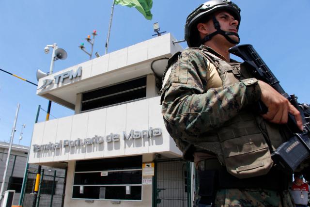 A member of the Armed Forces guards the Manta Port Terminal in Manta, Ecuador, on February 16, 2026. (Photo by Gerardo MENOSCAL / AFP)