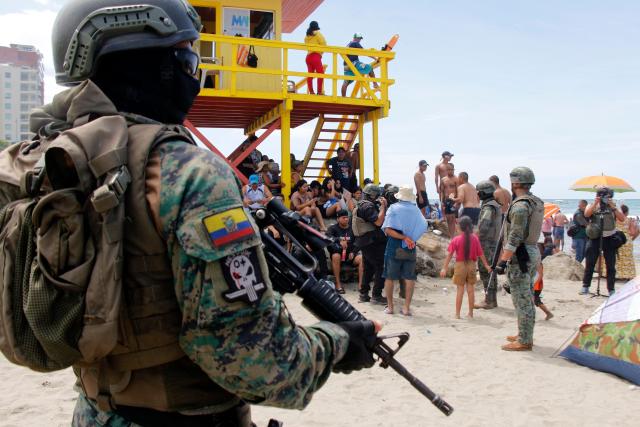 Members of the Armed Forces guard Jaramijo Beach in Manta, Ecuador, on February 16, 2026. (Photo by Gerardo MENOSCAL / AFP)
