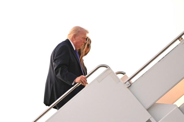 US President Donald Trump and First Lady Melania Trump make their way to board Air Force One before departing Palm Beach International Airport in West Palm Beach, Florida, on February 16, 2026. Trump is returning to Washington, DC, after spending the weekend at his Mar-a-Lago resort. (Photo by Mandel NGAN / AFP)