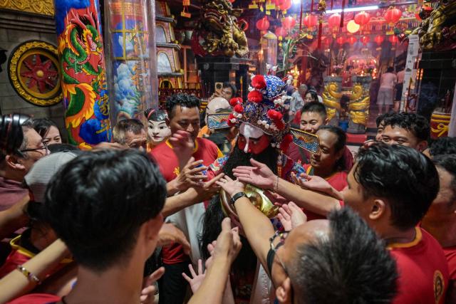 People visit Hong San Koo Tee temple on the first day of the Lunar New Year of the Horse in Surabaya on February 17, 2026. (Photo by JUNI KRISWANTO / AFP)