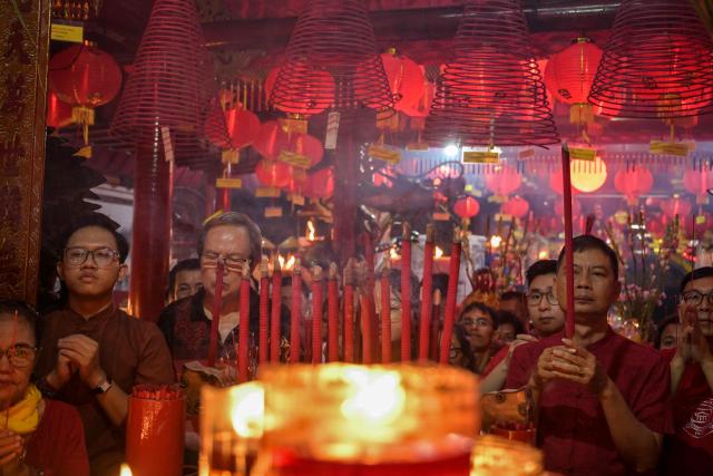 People offer prayers on the first day of the Lunar New Year of the Horse at Hong San Koo Tee temple in Surabaya on February 17, 2026. (Photo by JUNI KRISWANTO / AFP)