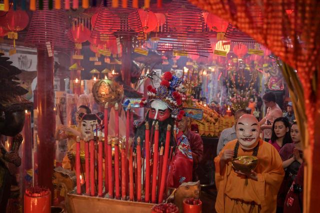 People offer prayers on the first day of the Lunar New Year of the Horse at Hong San Koo Tee temple in Surabaya on February 17, 2026. (Photo by JUNI KRISWANTO / AFP)