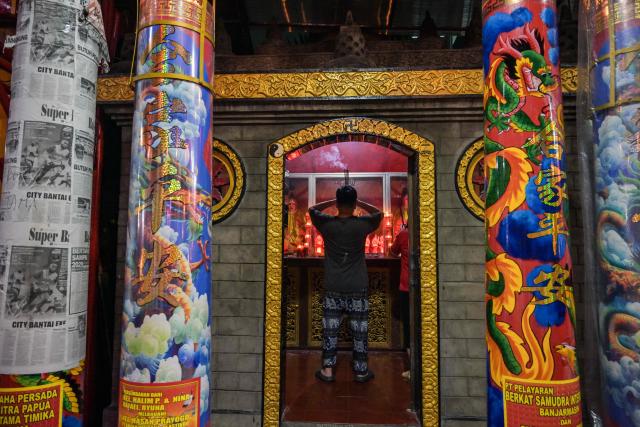 A man offers prayers on the first day of the Lunar New Year of the Horse at Hong San Koo Tee temple in Surabaya on February 17, 2026. (Photo by JUNI KRISWANTO / AFP)