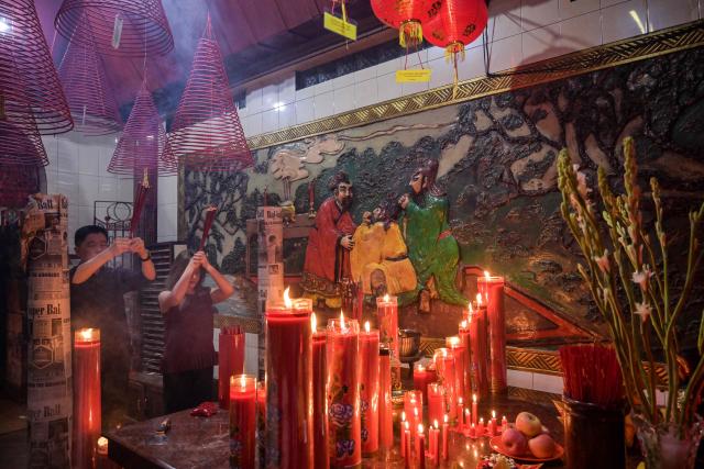 People offer prayers on the first day of the Lunar New Year of the Horse at Hong San Koo Tee temple in Surabaya on February 17, 2026. (Photo by JUNI KRISWANTO / AFP)