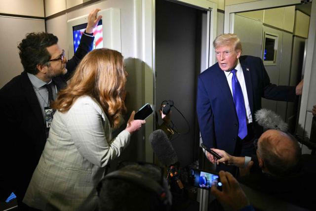 US President Donald Trump speaks to reporters while in flight on Air Force One, en route Joint Base Andrews from West Palm Beach, Florida on February 16, 2026. (Photo by Mandel NGAN / AFP)