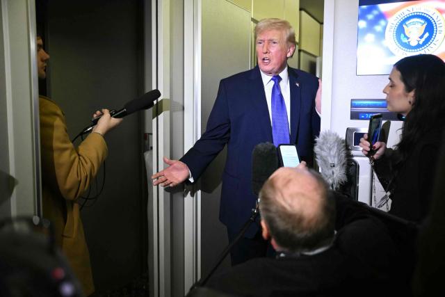 US President Donald Trump speaks to reporters while in flight on Air Force One, en route Joint Base Andrews from West Palm Beach, Florida on February 16, 2026. (Photo by Mandel NGAN / AFP)
