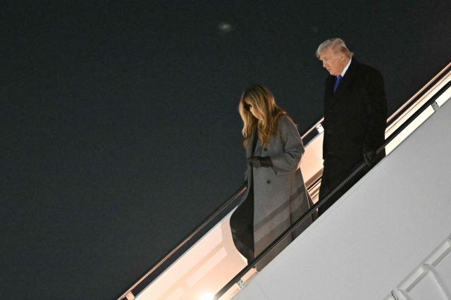US President Donald Trump and First Lady Melania Trump step off Air Force One upon arrival at Joint Base Andrews in Maryland, on February 16, 2026. Trump is returning to Washington, DC after spending the holiday weekend at his Mar-a-Lago resort. (Photo by Mandel NGAN / AFP)