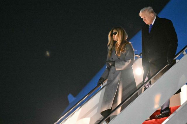 US President Donald Trump and First Lady Melania Trump step off Air Force One upon arrival at Joint Base Andrews in Maryland, on February 16, 2026. Trump is returning to Washington, DC after spending the holiday weekend at his Mar-a-Lago resort. (Photo by Mandel NGAN / AFP)