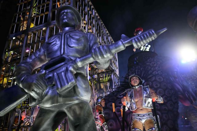 A reveller of the Mocidade Independente de Padre Miguel samba school performs on a float during the second night of the Rio Carnival at the Marques de Sapucai Sambadrome in Rio de Janeiro, Brazil on February 16, 2026. (Photo by Mauro PIMENTEL / AFP)