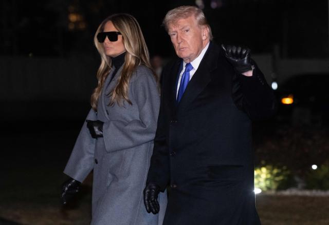 US President Donald Trump and First Lady Melania Trump walk across the South Lawn of the White House after arriving on Marine One following a weekend trip to Florida, in Washington, DC, on February 16, 2026. (Photo by SAUL LOEB / AFP)