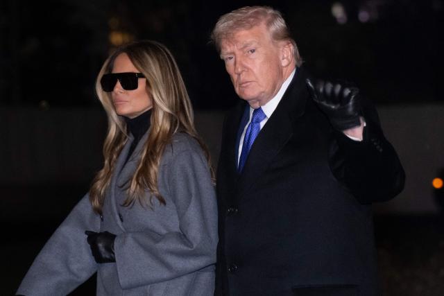 US President Donald Trump and First Lady Melania Trump walk across the South Lawn of the White House after arriving on Marine One following a weekend trip to Florida, in Washington, DC, on February 16, 2026. (Photo by SAUL LOEB / AFP)