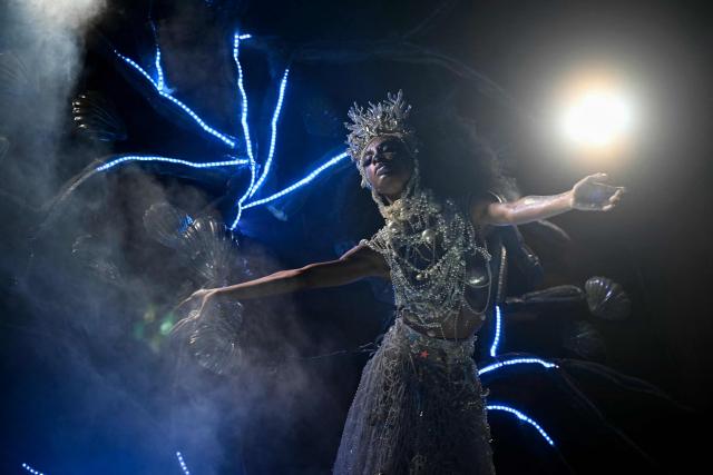 A reveller of the Beija-Flor de Nipolis samba school performs on a float during the second night of the Rio Carnival at the Marques de Sapucai Sambadrome in Rio de Janeiro, Brazil, early on February 17, 2026. (Photo by Mauro PIMENTEL / AFP)