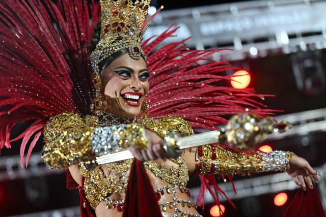 Brazilian actress Juliana Paes performs during the parade of the Unidos do Viradouro samba school on the second night of the Rio Carnival at the Marques de Sapucai Sambadrome in Rio de Janeiro, Brazil, early on February 17, 2026. (Photo by Mauro PIMENTEL / AFP)
