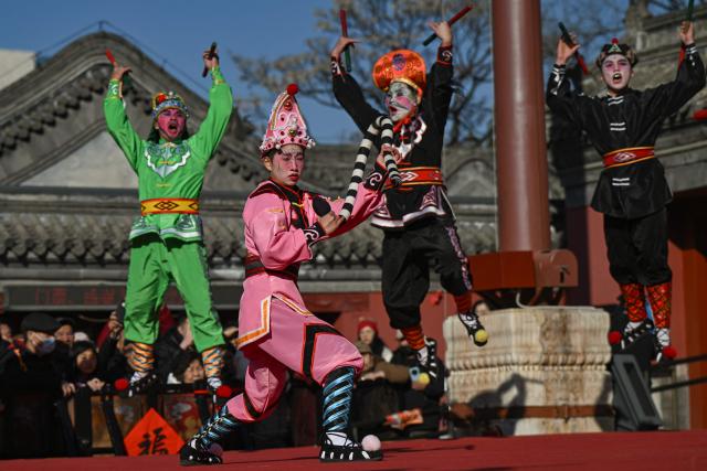 Yingge dancers perform at a temple on the first day of the Lunar New Year of the Horse in Beijing on February 17, 2026. (Photo by Pedro PARDO / AFP)