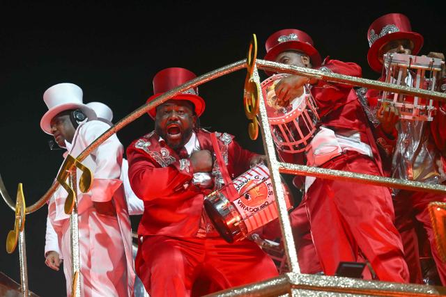 Revellers of the Unidos do Viradouro samba school perform on a float during the second night of the Rio Carnival at the Marques de Sapucai Sambadrome in Rio de Janeiro, Brazil, early on February 17, 2026. (Photo by Mauro PIMENTEL / AFP)