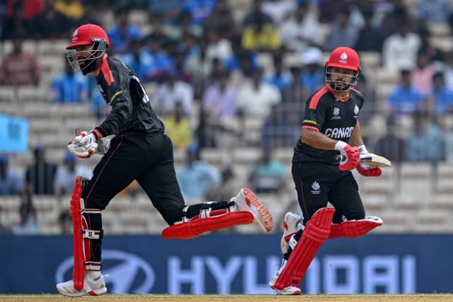 Canada's Yuvraj Samra (L) and captain Dilpreet Bajwa run between the wickets during the 2026 ICC Men's T20 Cricket World Cup group stage match between Canada and New Zealand at the MA Chidambaram Stadium in Chennai on February 17, 2026. (Photo by R. Satish BABU / AFP)