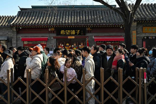 People queue to enter the Lama Temple on the first day of the Lunar New Year of the Horse in Beijing on February 17, 2026. (Photo by Adek BERRY / AFP)