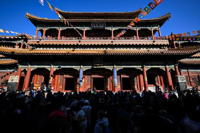 People pray at the Lama Temple on the first day of the Lunar New Year of the Horse in Beijing on February 17, 2026. (Photo by Adek BERRY / AFP)