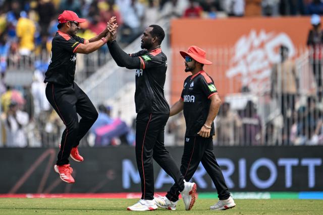 Canada's Dilon Heyliger (C) celebrates with teammates after taking the wicket of New Zealand's Finn Allen during the 2026 ICC Men's T20 Cricket World Cup group stage match between Canada and New Zealand at the MA Chidambaram Stadium in Chennai on February 17, 2026. (Photo by R. Satish BABU / AFP)