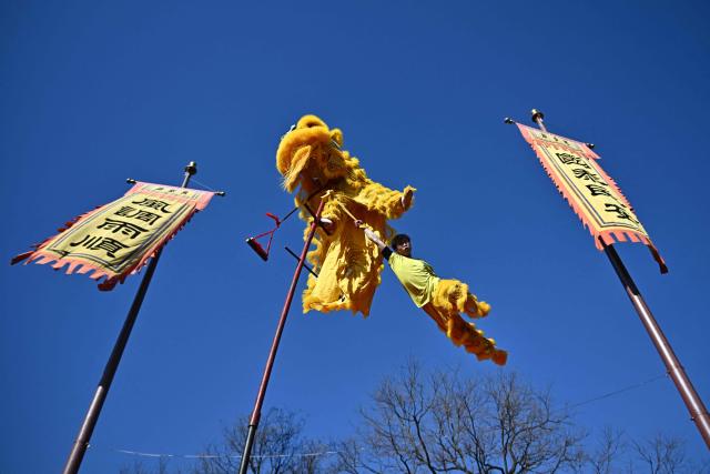 Lion dancers perform at Dongyue Temple on the first day of the Lunar New Year of the Horse in Beijing on February 17, 2026. (Photo by Pedro PARDO / AFP)