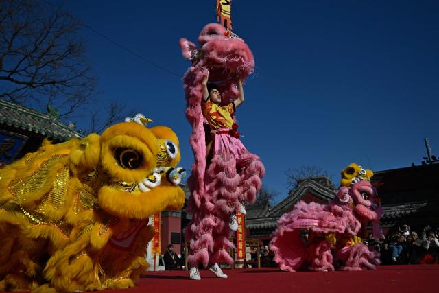 Lion dancers perform at Dongyue Temple on the first day of the Lunar New Year of the Horse in Beijing on February 17, 2026. (Photo by Pedro PARDO / AFP)
