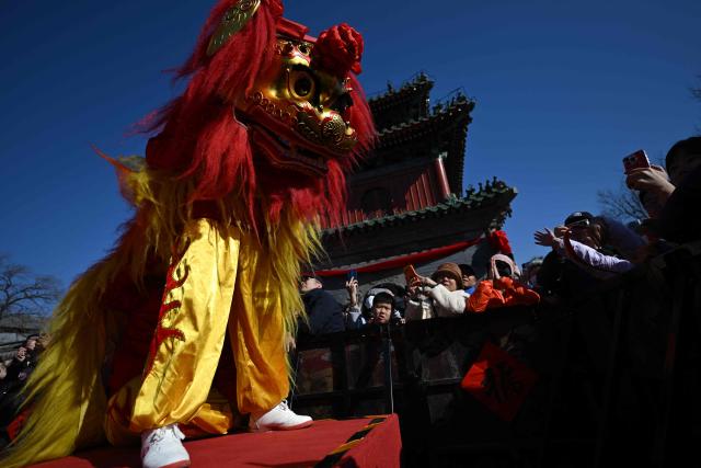 Lion dancers perform at Dongyue Temple on the first day of the Lunar New Year of the Horse in Beijing on February 17, 2026. (Photo by Pedro PARDO / AFP)