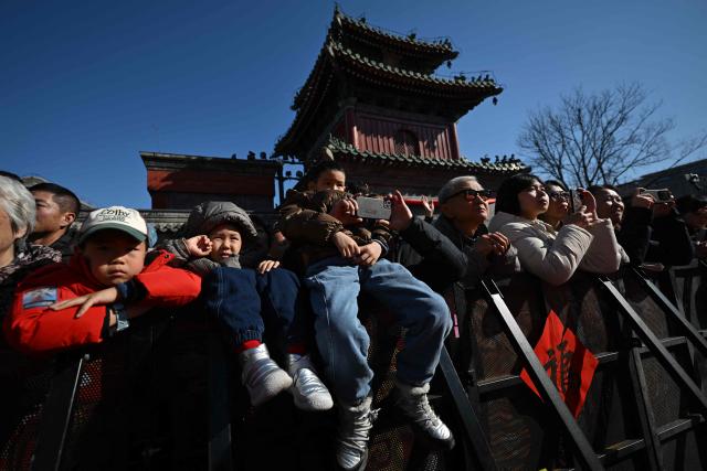People look at a Lion dance performance at the Dongyue Temple on the first day of the Lunar New Year of the Horse in Beijing on February 17, 2026. (Photo by Pedro PARDO / AFP)