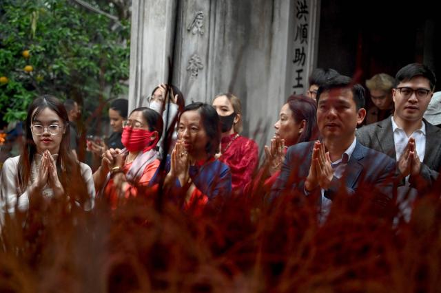 Devotees pray at the Kim Lien Temple on the first day of the Lunar New Year or Tet in Hanoi on February 17, 2026. (Photo by Nhac NGUYEN / AFP)