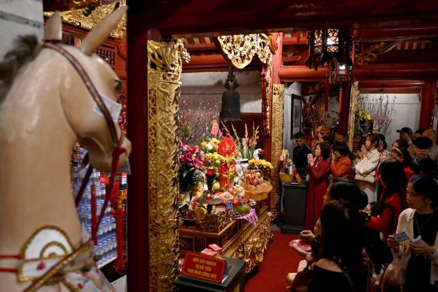 Devotees pray at the Kim Lien Temple on the first day of the Lunar New Year or Tet in Hanoi on February 17, 2026. (Photo by Nhac NGUYEN / AFP)