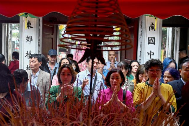 Devotees pray at the Kim Lien Temple on the first day of the Lunar New Year or Tet in Hanoi on February 17, 2026. (Photo by Nhac NGUYEN / AFP)