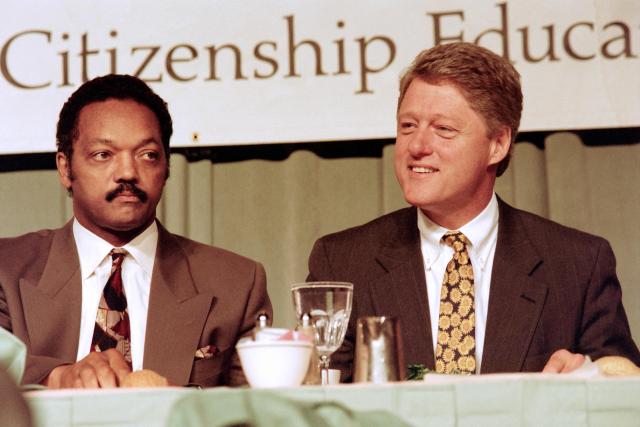 (FILES) Democratic Presidential hopeful Bill Clinton (R) sits with Jesse Jackson during a luncheon at the national conference "Rebuild America... 92 and Beyond" sponsored by Jackson's National Rainbow Coalition on June 13, 1992. Veteran US civil rights activist Reverend Jesse Jackson died on February 17, 2026, his family said in a statement. He was 84. (Photo by Jennifer LAW / AFP)