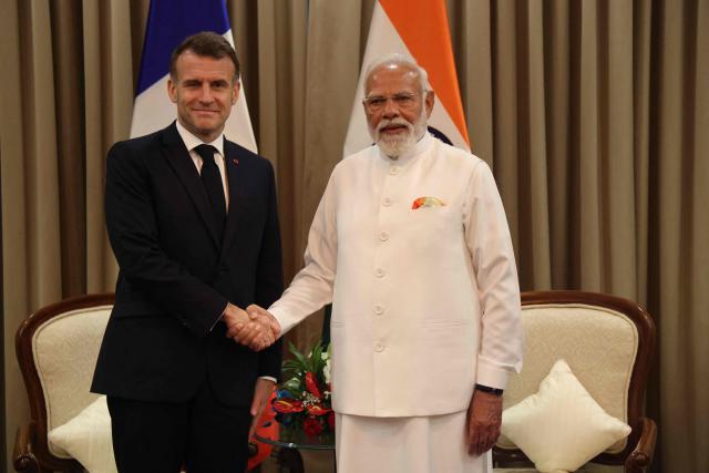 France's President Emmanuel Macron (L) and India's Prime Minister Narendra Modi shake hands during a bilateral meeting in Mumbai on February 17, 2026. (Photo by Ludovic MARIN / POOL / AFP)