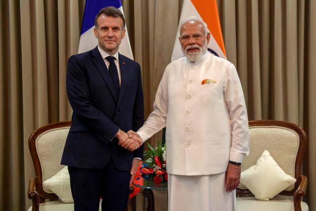 France's President Emmanuel Macron (L) and India's Prime Minister Narendra Modi shake hands during a bilateral meeting in Mumbai on February 17, 2026. (Photo by Ludovic MARIN / POOL / AFP)