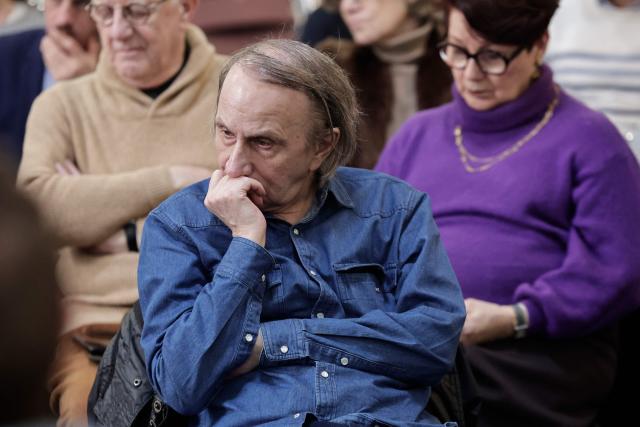 French writer Michel Houellebecq looks on as he attends a meeting on euthanasia organised by the association "Les Eligibles et leurs Aidants" as French National Assembly debates on the assisted dying bill at the 'Centre d'etude, de documentation, d'information et d'action sociale' CEDIAS in Paris on February 17, 2026. (Photo by STEPHANE DE SAKUTIN / AFP)