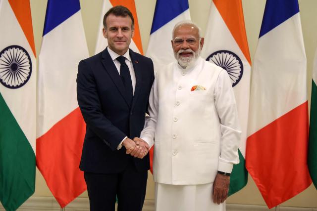 TOPSHOT - France's President Emmanuel Macron (L) and India's Prime Minister Narendra Modi shake hands as they hold a bilateral meeting in Mumbai on February 17, 2026. (Photo by Ludovic MARIN / AFP)