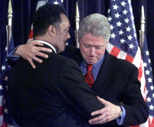 (FILES) US President Bill Clinton (R) hugs the Rev. Jesse Jackson on stage at the Keep Hope Alive Reception at the Hotel Washington 07 December 1999 in Washington, DC. Veteran US civil rights activist Reverend Jesse Jackson died on February 17, 2026, his family said in a statement. He was 84. (Photo by Tim SLOAN / AFP)