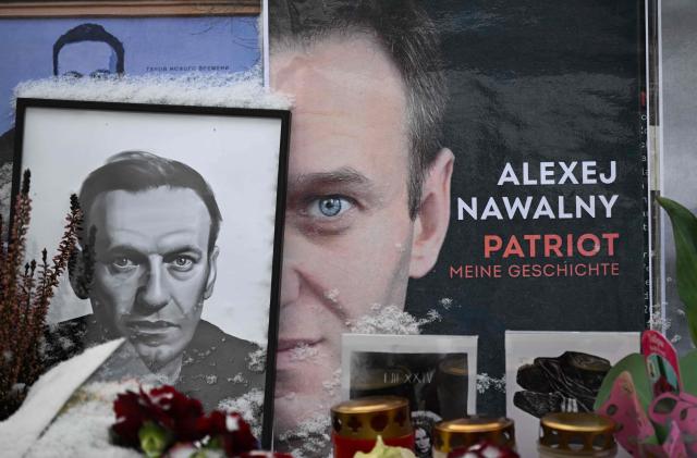 Flowers and candles are arranged next to pictures of late Russian opposition leader Alexei Navalny at a makeshift memorial, in front of the Russian embassy in Berlin on February 17, 2026, one day after the second anniversary of his death. Polonium, Novichok and now dart frog poison: the finding that Russian opposition leader Alexei Navalny was killed with a rare toxin has revived the spectre of Moscow's use of poisons against opponents -- a hallmark of its secret services, according to experts.  The neurotoxin epibatidine, found in Ecuadoran frogs, was identified in laboratory analyses of samples from Navalny's body, the British, Swedish, French, German and Dutch governments said in a joint statement released on February 14, 2026 at the Munich Security Conference . (Photo by RALF HIRSCHBERGER / AFP) / NAVALNY HAS BEEN DECLARED "EXTREMIST" BY RUSSIAN AUTHORITIES. IN RUSSIA, ANYBODY WHO MENTIONS NAVALNY OR HIS ANTI-CORRUPTION FOUNDATION WITHOUT STATING THAT THEY HAVE BEEN DECLARED "EXTREMIST" IS SUBJECT TO FINES OR UP TO FOUR YEARS IN PRISON FOR REPEATED OFFENCES. / 