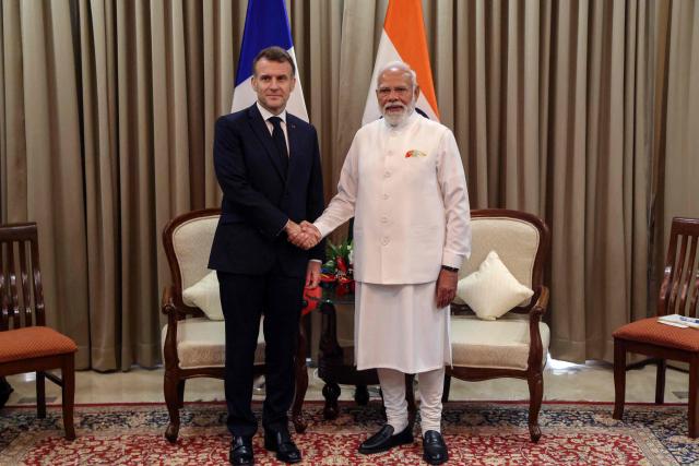 France's President Emmanuel Macron (L) and India's Prime Minister Narendra Modi shake hands during a bilateral meeting in Mumbai on February 17, 2026. (Photo by Ludovic MARIN / POOL / AFP)