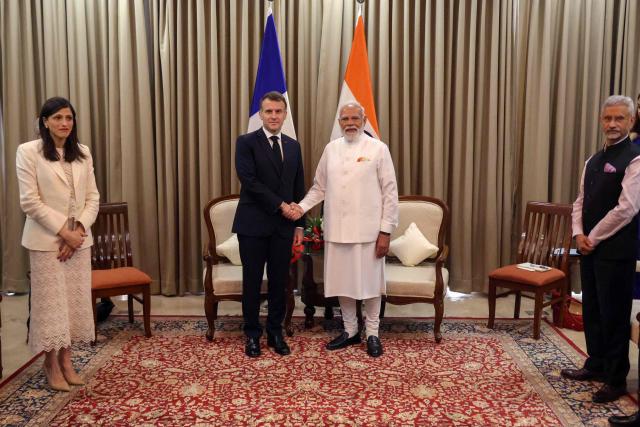 France's President Emmanuel Macron (2nd L) and India's Prime Minister Narendra Modi (2nd R) shake hands during a bilateral meeting in Mumbai on February 17, 2026. (Photo by Ludovic MARIN / POOL / AFP)