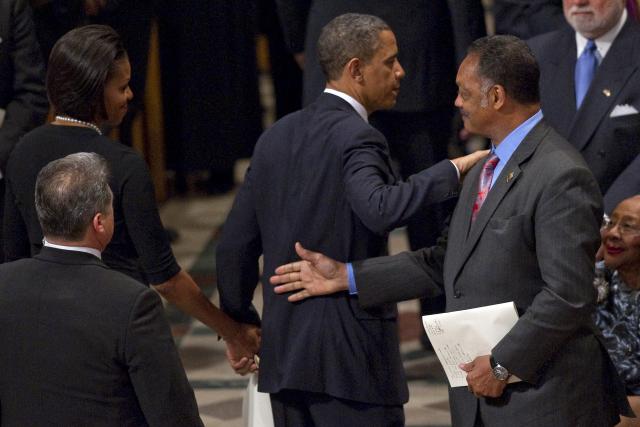 (FILES) US President Barack Obama (C) pats Reverend Jesse Jackson (R) on the back as he reaches out to shake hands with First Lady Michelle Obama (L) at the funeral service for Dr. Dorothy Height at Washington National Cathedral in Washington, DC, April 29, 2010. Veteran US civil rights activist Reverend Jesse Jackson died on February 17, 2026, his family said in a statement. He was 84. (Photo by Jim WATSON / AFP)